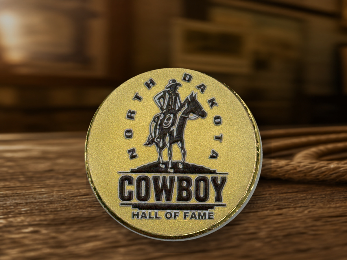North Dakota Cowboy Hall of Fame emblem coin in a Western lifestyle setting