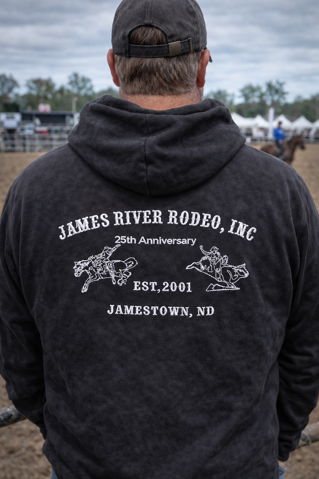 Back of a black James River Rodeo hoodie with white embroidery