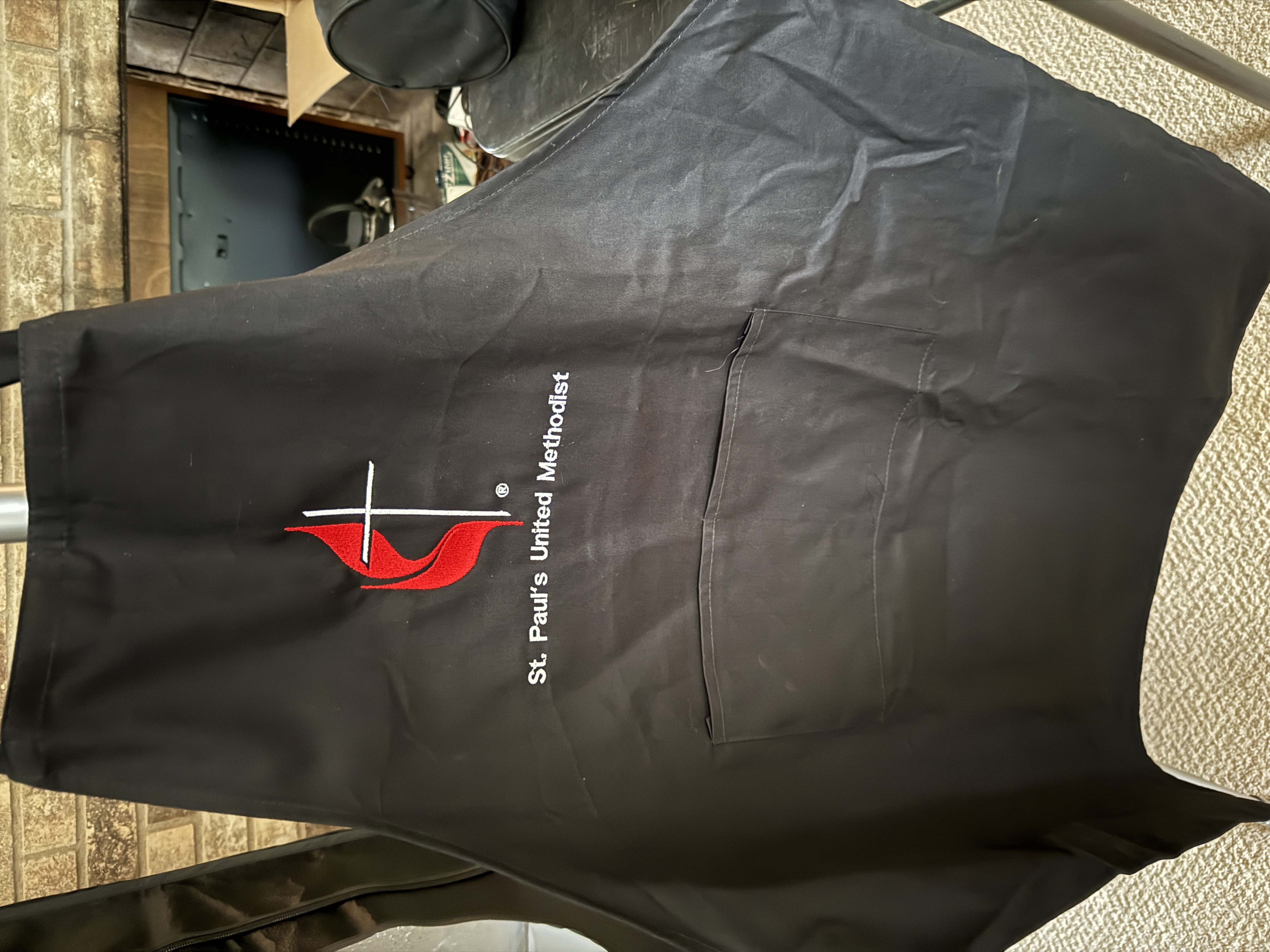 Full black two-pocket apron embroidered for St. Paul’s United Methodist