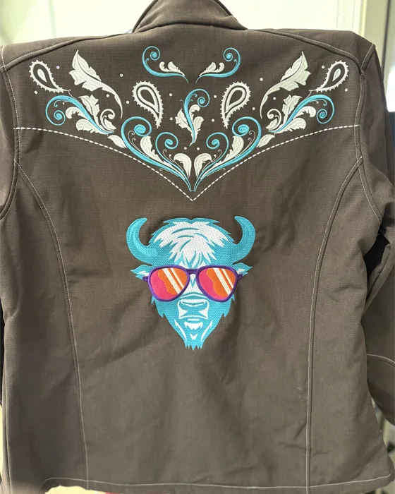 Turquoise embroidered artwork on a brown jacket
