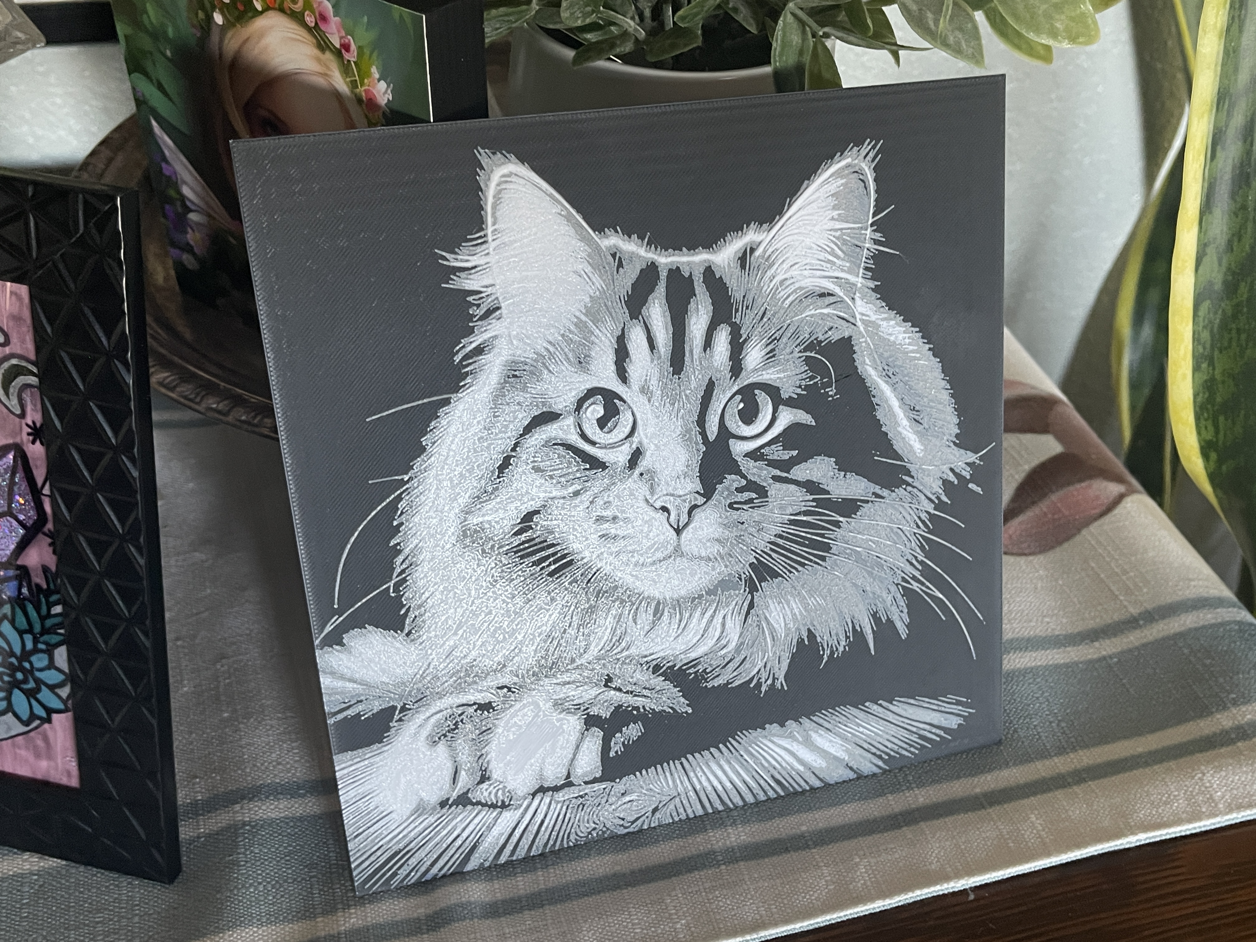 HueForge cat portrait printed in white on a dark background